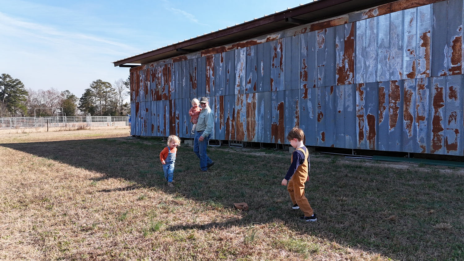 Pops with kids at the blue barn on Mule Creek Ranch